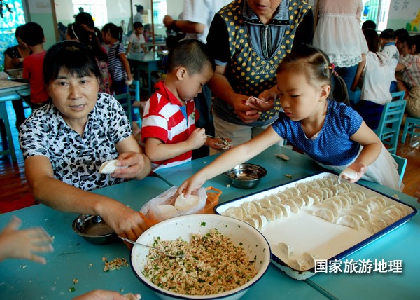 　　9月19日，三位孩子在搬运自己和亲人一起包的饺子，很是开心的样子。